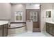 Spacious bathroom with dual vanities, garden tub and separate glass shower at 9501 Hempel Cove Blvd, Windermere, FL 34786