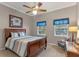 Cozy bedroom features a comfortable bed, ceiling fan, and bright windows, creating a relaxing and inviting space at 9501 Hempel Cove Blvd, Windermere, FL 34786