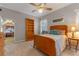 Bright bedroom with warm wooden furniture, neutral walls, and soft carpet flooring, creating a cozy and inviting atmosphere at 9501 Hempel Cove Blvd, Windermere, FL 34786