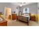 Cozy bedroom features a ceiling fan, wooden furniture, and a connected bathroom for added convenience at 9501 Hempel Cove Blvd, Windermere, FL 34786