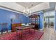 Formal dining room with blue walls, hardwood floors, and elegant chandelier at 9501 Hempel Cove Blvd, Windermere, FL 34786