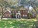 Charming two-story red brick home with a well-manicured lawn and mature trees at 9501 Hempel Cove Blvd, Windermere, FL 34786