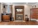 Living room with a fireplace, hardwood floors, and natural light at 9501 Hempel Cove Blvd, Windermere, FL 34786