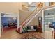 Grand foyer with a curved staircase, hardwood floors, and elegant decor at 9501 Hempel Cove Blvd, Windermere, FL 34786