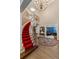 Spacious foyer featuring a curved staircase, hardwood floors, and elegant decor at 9501 Hempel Cove Blvd, Windermere, FL 34786
