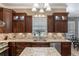 Charming kitchen with custom cabinets, granite countertops, stainless steel appliances, and hardwood floors at 9501 Hempel Cove Blvd, Windermere, FL 34786