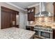 This kitchen boasts custom cabinets, granite countertops, and stainless steel appliances at 9501 Hempel Cove Blvd, Windermere, FL 34786