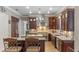 Gourmet kitchen with dark wood cabinets, stainless steel appliances, and a kitchen island at 9501 Hempel Cove Blvd, Windermere, FL 34786