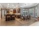 Open-concept kitchen and dining area with dark wood cabinets and modern light fixtures at 9501 Hempel Cove Blvd, Windermere, FL 34786
