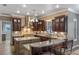 Well-appointed kitchen featuring dark wood cabinets, granite countertops, and modern appliances at 9501 Hempel Cove Blvd, Windermere, FL 34786