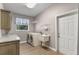 Functional laundry room complete with sink, storage, and natural light at 9501 Hempel Cove Blvd, Windermere, FL 34786