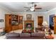 Comfortable living room with a cozy fireplace and built-in wooden shelving at 9501 Hempel Cove Blvd, Windermere, FL 34786