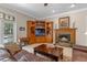 Elegant living room with a cozy fireplace, built-in shelving, and a comfortable leather sofa at 9501 Hempel Cove Blvd, Windermere, FL 34786
