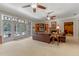 Bright living room with a fireplace, leather couches, and view of a pool through stained glass doors at 9501 Hempel Cove Blvd, Windermere, FL 34786