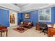 Comfortable sitting room with a fireplace, sofa, desk, and blue walls at 9501 Hempel Cove Blvd, Windermere, FL 34786