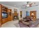 Spacious living room featuring a fireplace, built-in shelves, and leather couches at 9501 Hempel Cove Blvd, Windermere, FL 34786