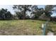 Large grassy backyard with mature trees and a wooden fence at 990 Liskeard Ave, Orange City, FL 32763
