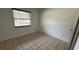 Empty bedroom with tiled floors and a window at 990 Liskeard Ave, Orange City, FL 32763