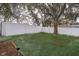 Spacious backyard with a privacy fence and mature tree at 245 Heronwood Cir, Deltona, FL 32725