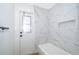 Simple bathroom with marble tile and a bathtub at 245 Heronwood Cir, Deltona, FL 32725