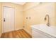 Bright laundry room with utility sink and ample shelving at 245 Heronwood Cir, Deltona, FL 32725