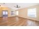 Living room with wood-look floors, ceiling fan, and sliding doors at 245 Heronwood Cir, Deltona, FL 32725