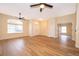 Spacious living room with wood-look floors and ceiling fans at 245 Heronwood Cir, Deltona, FL 32725