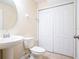 Bathroom with toilet, sink, and built-in storage at 112 Augustus Pt, Sanford, FL 32773