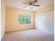 Spacious bedroom with ceiling fan, window, and double doors at 112 Augustus Pt, Sanford, FL 32773