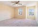 Bright bedroom with neutral walls, carpet, and two large windows at 112 Augustus Pt, Sanford, FL 32773