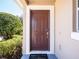 Brown front door and welcome mat at 112 Augustus Pt, Sanford, FL 32773