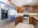 Stainless steel appliances and wood cabinets in kitchen at 112 Augustus Pt, Sanford, FL 32773