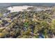 Aerial view of property and surrounding neighborhood near a lake at 117 E Goodheart Ave, Lake Mary, FL 32746