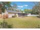 Large backyard with grassy lawn and screened porch at 117 E Goodheart Ave, Lake Mary, FL 32746