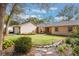 House exterior showcasing landscaping and stone pathway at 117 E Goodheart Ave, Lake Mary, FL 32746