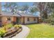 Welcoming front entry with walkway, landscaping, and wood accents at 117 E Goodheart Ave, Lake Mary, FL 32746