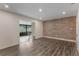 Living room with wood-look floors and access to a screened porch at 117 E Goodheart Ave, Lake Mary, FL 32746