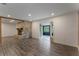 Living room with fireplace, screened porch access, and wood floors at 117 E Goodheart Ave, Lake Mary, FL 32746