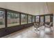 Relaxing screened porch with tiled floor and seating at 117 E Goodheart Ave, Lake Mary, FL 32746