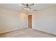 Carpeted bedroom with ceiling fan and door to hallway at 12340 Tavares Ridge Ln # 111, Tavares, FL 32778