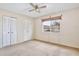 Carpeted bedroom with double door closet and ceiling fan at 12340 Tavares Ridge Ln # 111, Tavares, FL 32778