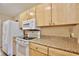 Kitchen features light wood cabinets and a white stove top at 12340 Tavares Ridge Ln # 111, Tavares, FL 32778