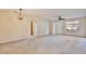 Bright living room with carpeted floor and exterior access at 12340 Tavares Ridge Ln # 111, Tavares, FL 32778