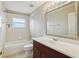 Clean bathroom featuring a tub, toilet and vanity with a large ornate mirror at 1395 Legendary Blvd, Clermont, FL 34711