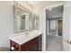 Bathroom with vanity, mirror and view into hallway at 1395 Legendary Blvd, Clermont, FL 34711