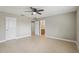 Bedroom with ceiling fan and access to bathroom and hallway at 1395 Legendary Blvd, Clermont, FL 34711