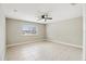 Bedroom with ceiling fan and tile flooring, featuring a window with a view at 1395 Legendary Blvd, Clermont, FL 34711