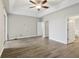 Spacious bedroom with hardwood floors, ceiling fan and access to the bathroom at 1395 Legendary Blvd, Clermont, FL 34711