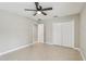 Comfortable bedroom with tile floors, ceiling fan and double door closet at 1395 Legendary Blvd, Clermont, FL 34711