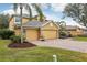 Two-story house with a three-car garage and landscaped yard at 1395 Legendary Blvd, Clermont, FL 34711